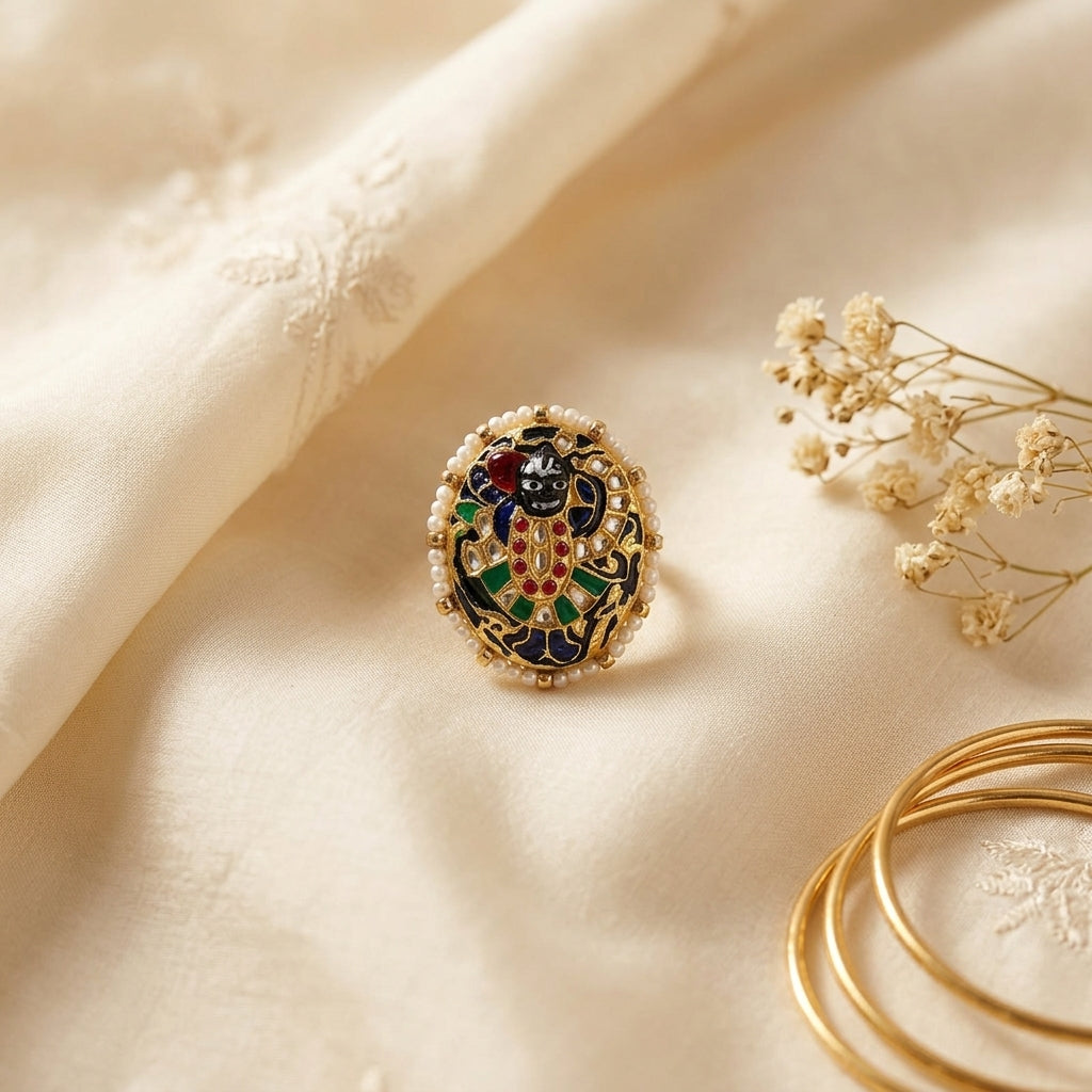 Looking for a Sreenathji Ring? 22kt gold traditional Indian ring with Sreenathji divine motif, multicolour meenakari enamel and pearl border, perfect for bridal and festive wear