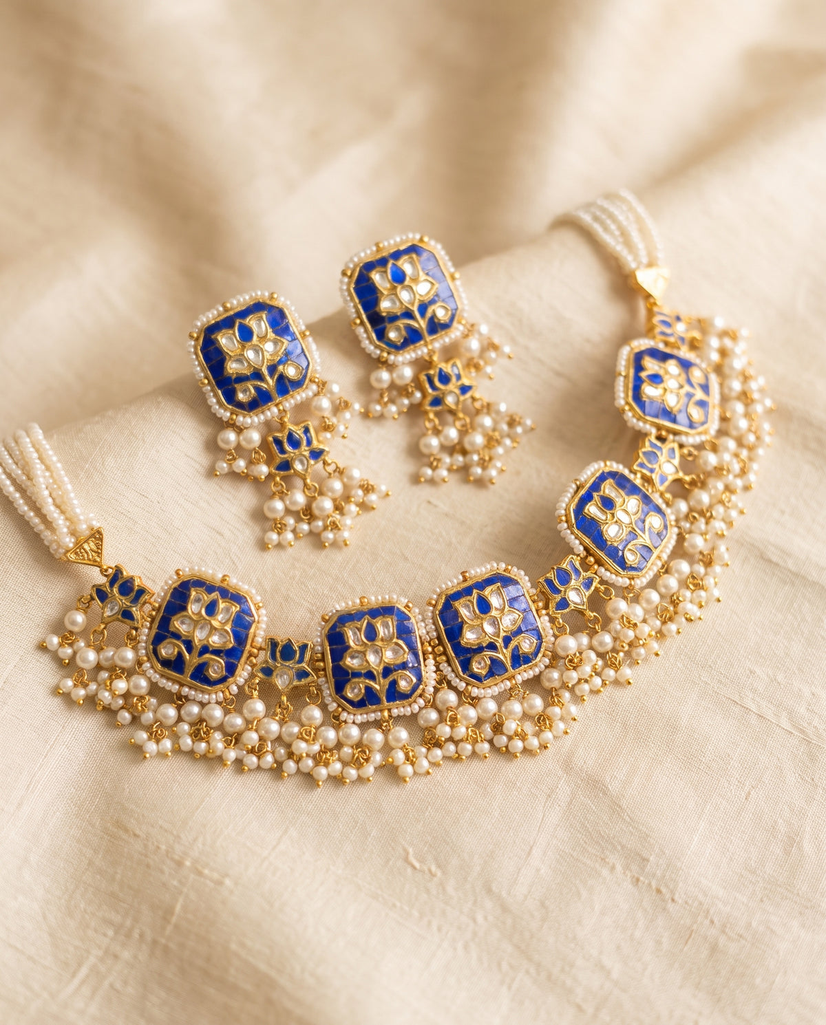 Handcrafted 22kt Gold Blue Lotus Set with 5 Carat Certified Syndicate Polki and Blue Semi Precious Stones in Lotus Motif Thapa Work