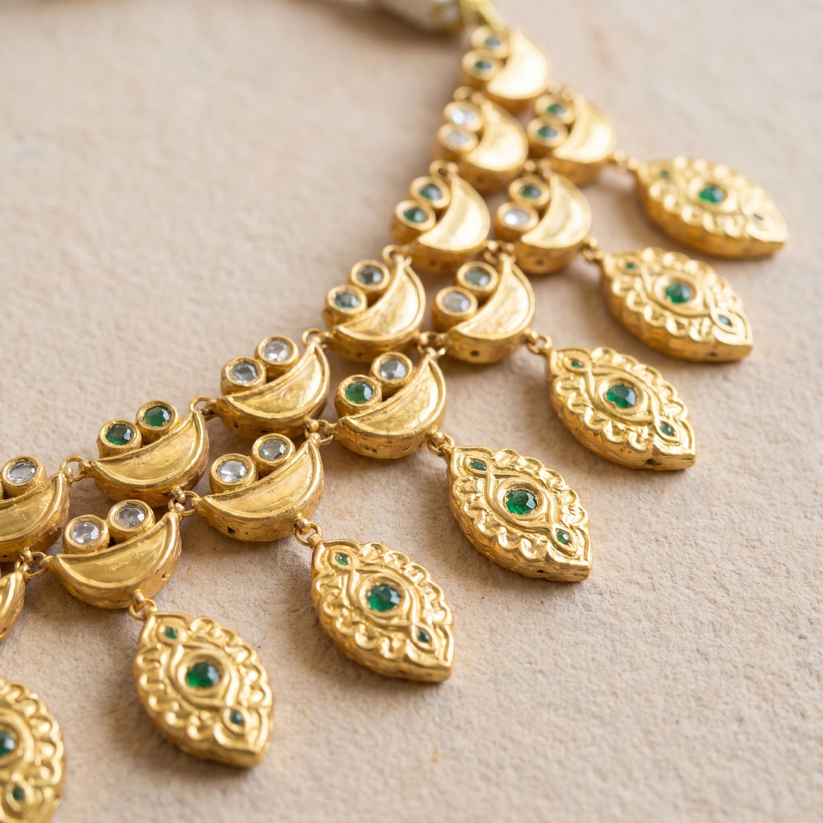 Handcrafted 22kt Gold Emerald Half Moon Set with 5 Carat Certified Syndicate Polki and Emerald Green Semi Precious Stones in Crescent Thapa Work