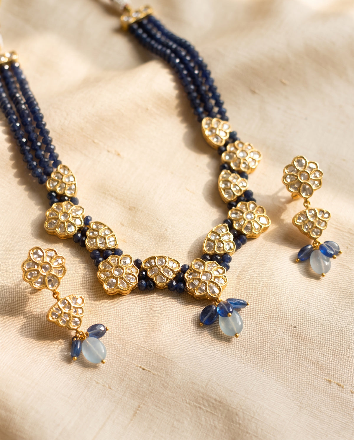 Handcrafted 22kt Gold Jakarti Set with 7 Carat Certified Syndicate Polki and Blue Bead Drops in Thapa Work